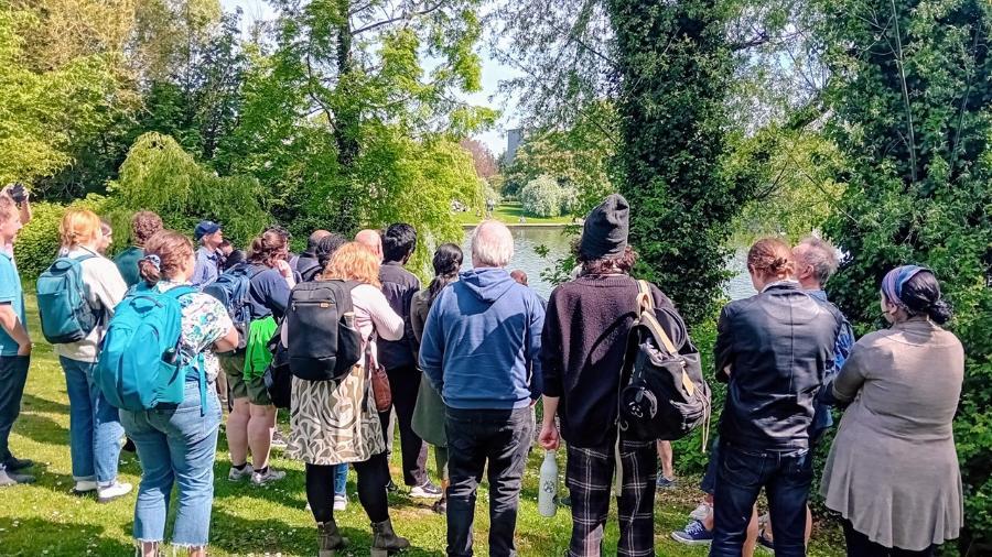 A group of people in front of some trees